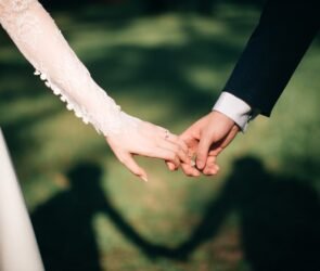 man and woman holding hands focus photo